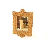 Heavy ornate gilt framed wall mirror, 97cm x 68cm