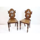 Pair of Victorian Mahogany Hall Chairs with shaped backs, solid seats and raised on turned legs,