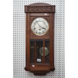 An oak hanging wall clock, with carved case, height 79cm