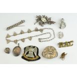 A small group of collectables to include military badges and sterling silver jewellery.