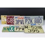 A collection of eight car number plates to include seven American examples from various states.