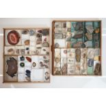 A large collection of cut stone specimens within two wooden trays.