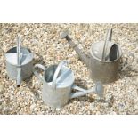 Three Galvanised Watering Cans, two with a rose, tallest 43cm high