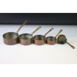 Set of five graduating copper pans with brass handles. (Circumference of largest pan 10.5cm)