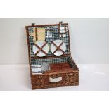 Four person picnic set in three wicker baskets, comprising cutlery, mugs, champagne glasses,