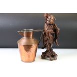 A carved wooden oriental figure together with a copper jug