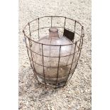 Glass Carboy Bottle held in a Wrought Iron Basket, 55cm high