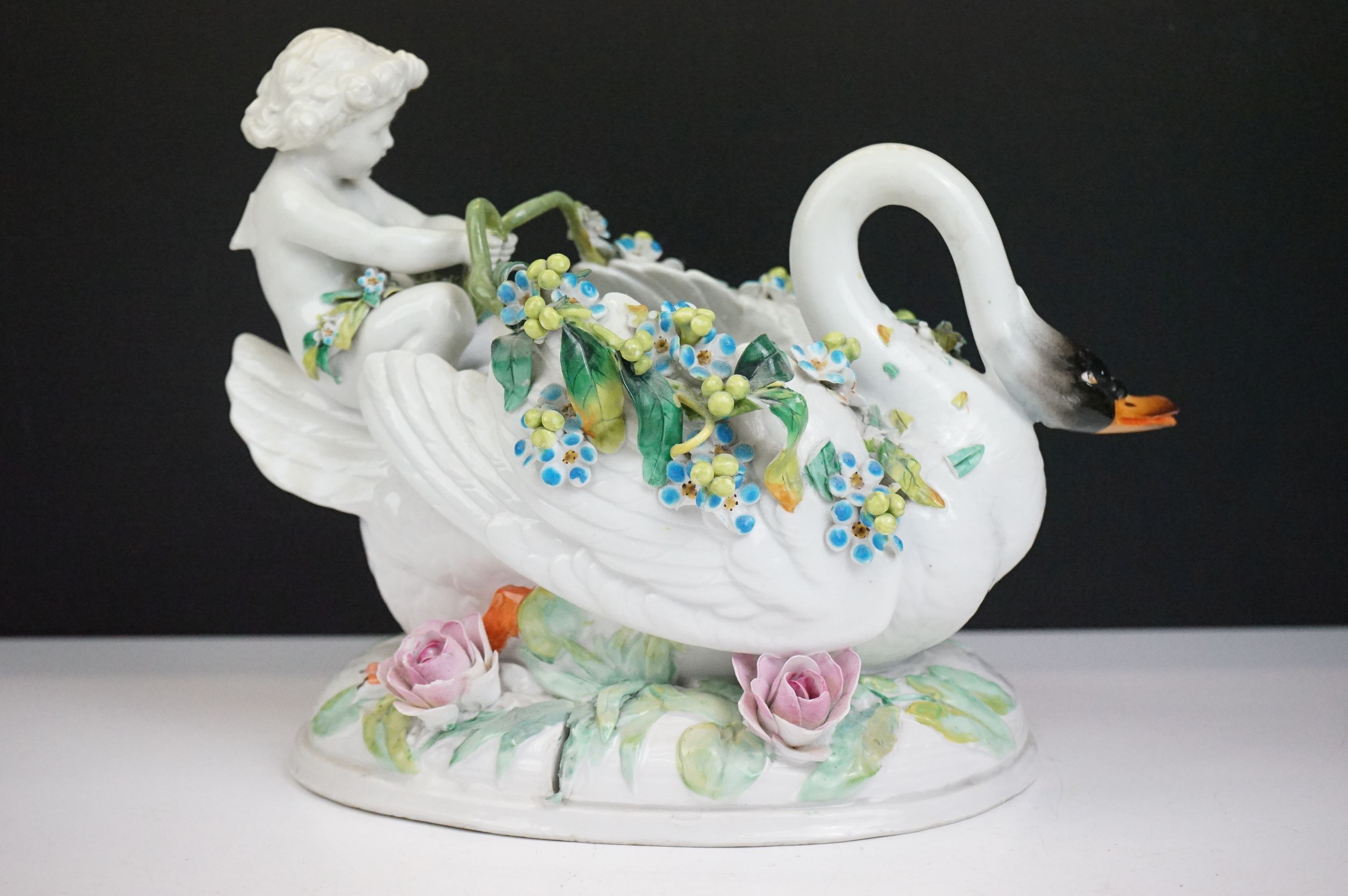 Group of three 19th Century porcelain pieces, comprising: a putti riding a flower encrusted swan, - Image 15 of 19