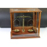 A cased set of pharmacists balance scales complete with weights.