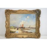 Gilt framed oil painting of a Dutch marine scene with fishing boats and figures on shoreline, 29.5 x