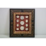 Eleven 19th century Grand Tour plaster intaglios medallions, framed within an ebonised and gilt