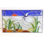 Stained glass panel depicting a bird in flight, with foliage in the foreground, 44 x 75cm