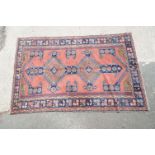 Pink Ground Rug with geometric pattern within a border, 253cm x 165cm