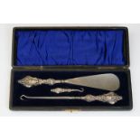 A fully hallmarked sterling silver button hook and shoe horn set in original fitted case.