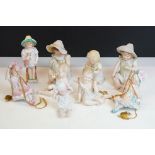 Eight Bisque Porcelain Piano Babies figures in various poses (featuring two on swings, tallest