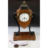 Regency style mantel clock, the satin walnut case of shield form encompassing a circular white