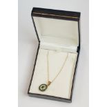 A fully hallmarked 9ct gold ladies necklace and pendant set with emeralds, within display case.