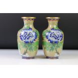 Pair of Chinese cloisonné baluster vases decorated with birds amongst flowers, on an olive green