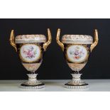 Pair of late 19th / early 20th century Continental porcelain twin-handled urn vases, with hand
