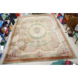 Large Green and Cream Ground Rug decorated flowers within a brown border, approx. 463cm x 356cm
