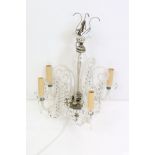 A vintage four branch glass chandelier with glass droplet strands.