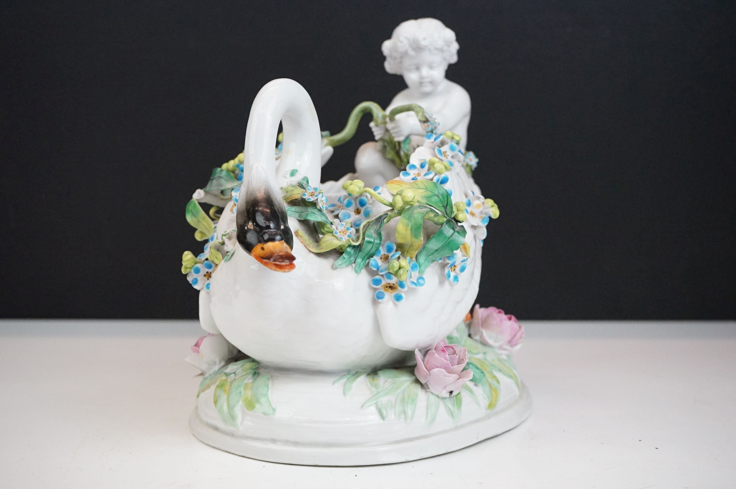 Group of three 19th Century porcelain pieces, comprising: a putti riding a flower encrusted swan, - Image 14 of 19