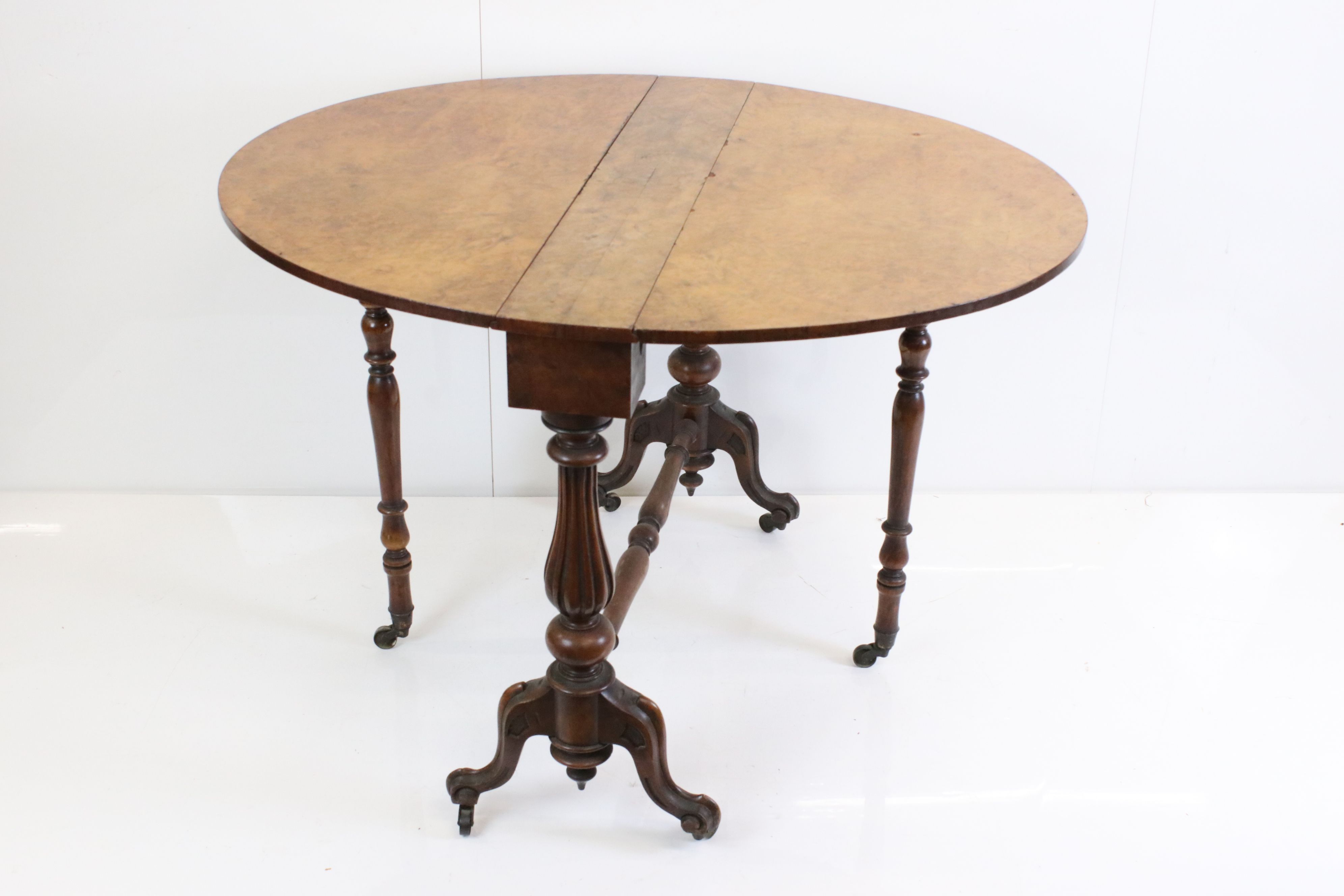 Victorian Burr Walnut and Walnut Oval Sutherland Table raised on reeded bulbous supports and