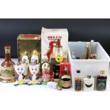 A collection of bottled alcohol to include Dimple Whisky, Bell's Whisky in ceramic Wade Bottles