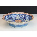 Early 20th Century Chinese pedestal bowl with scrolling floral decoration on a blue enamel ground,