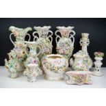 Collection of eleven 19th Century flower encrusted pieces, including vases, candlestick etc, the