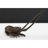 A bronze ornamental shrimp figure, measures approx 21cm.
