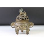 Chinese brass incense burner, the cover surmounted by a dog of foo, raised on three feet, seal