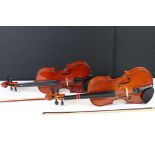 Two contemporary violins both complete with bows and cases.