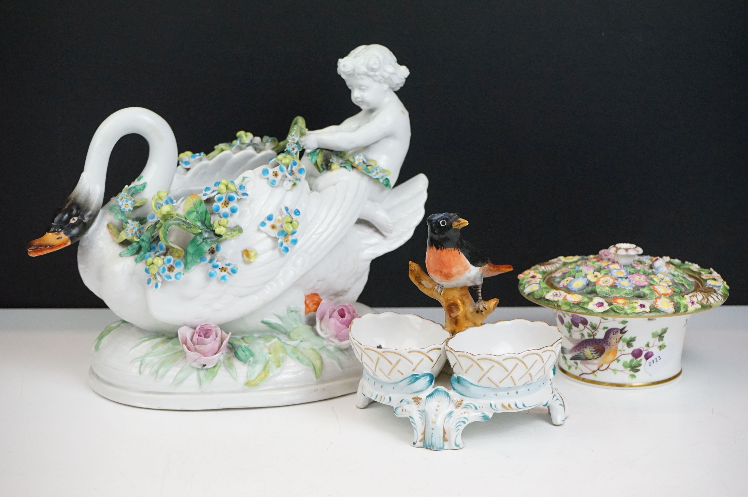 Group of three 19th Century porcelain pieces, comprising: a putti riding a flower encrusted swan,