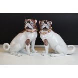 Near pair of 20th Century Dresden seated Pug figures, wearing gilt & pink collars, with hand painted