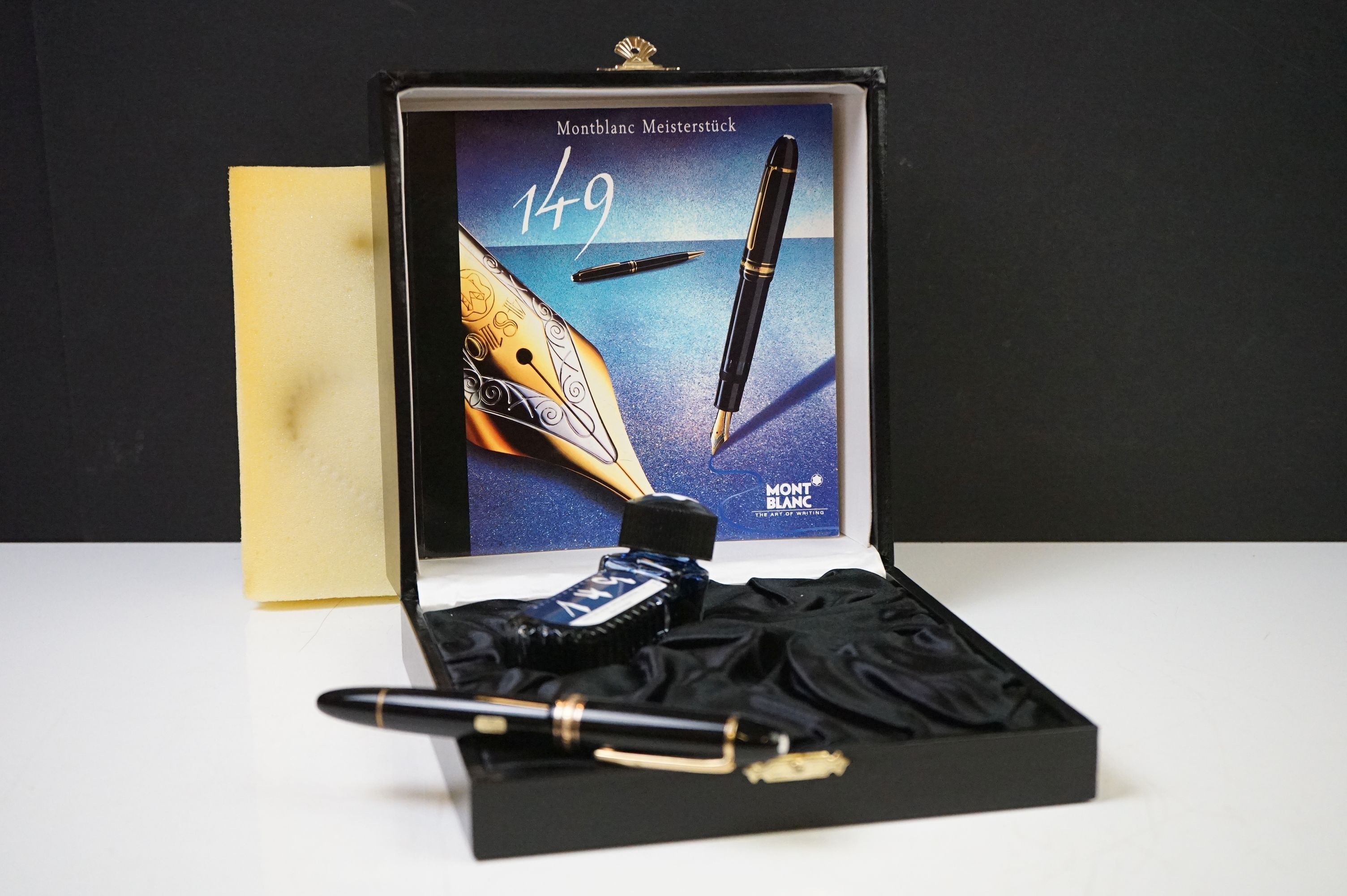 A boxed Mont Blanc 149 fountain pen with 18ct gold nib complete with ink bottle and related book and