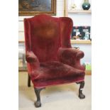 Wingback Armchair in the George III manner, raised on front cabriole legs with ball and claw feet,