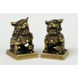 A pair of Chinese ink stamps in the form of Foo dogs.