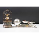 An atomic age Strato money box bank together with a wind up clock with turning caged birds.