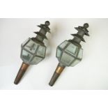 A pair of antique copper carriage lanterns, each with 12 bevelled glass panels.