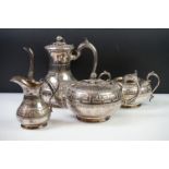 An antique silver plated tea set to include teapot, cream jug, sugar bowl and water jug decorated