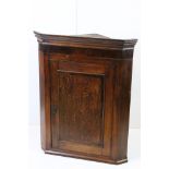 George III Hanging Mahogany and Oak Inlaid Corner Cabinet, the single door opening to shaped