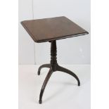 George III Mahogany Square Tilt Top Table, raised on a turned pedestal with three down swept legs,