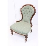 Victorian Walnut Nursing Chair with waisted back, green button back upholstery, raised on turned