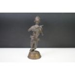 African spelter figure of a stylised warrior with weapon in hand, 25.5cm high