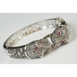 Silver hinged bangle in the form of leopards set with ruby eyes, designer style