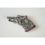 Silver dog brooch set on a ruby platform