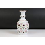 Early 20th century Bohemian glass vase of bottle form, with white overlay cut back to cranberry