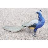 Garden ornament of a life size peacock with glass eyes, 150cm long