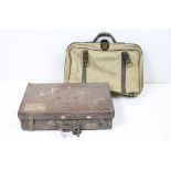 A vintage brown leather suitcase together with a canvas holdall with leather fittings.